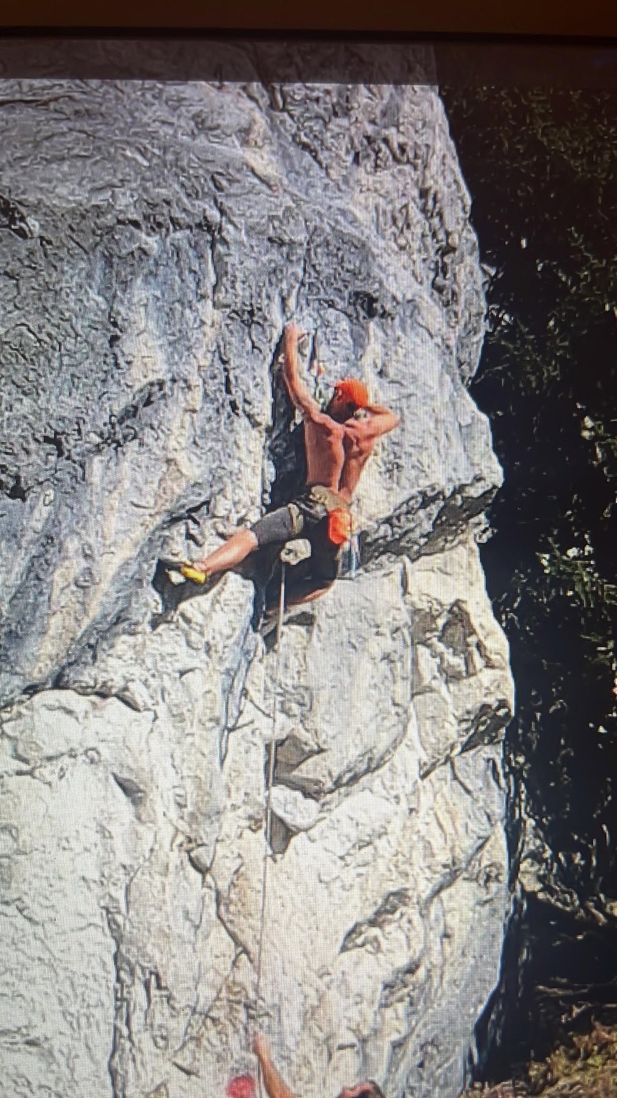 Danny Slinger, lead designer of 9C, climbing a 7C route on overhanging rock